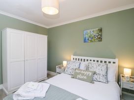 A bedroom with a bed and wardrobe at The Old Byre in Woodfalls