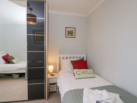 A bedroom with a bed and nightstand at The Old Byre in Woodfalls