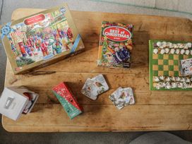 A coffee table with games and coasters at The Old Byre in Woodfalls