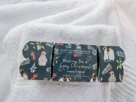A soap package with Christmas greeting on a white towel at The Old Byre in Woodfalls