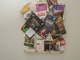 A collection of event brochures and maps at The Old Byre in Woodfalls