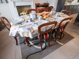 A dining room with a table set for breakfast at Cavan Cottage in Yoxford