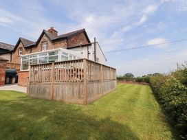 An outdoor area featuring a garden and wooden fence at Rose Bank Cottage in Dalston