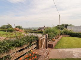 An outdoor view with a gate and garden at Rose Bank Cottage in Dalston