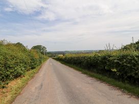 A road surrounded by bushes and trees in rural countryside at Rose Bank Cottage, Dalston