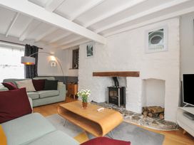 A living room with a sofa and coffee table at 3 River View in Looe
