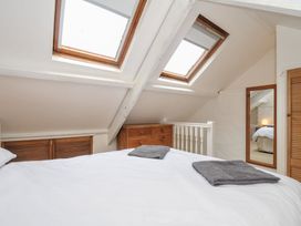 A bedroom with skylights and a bed at 3 River View, Looe
