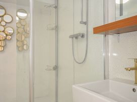 A bathroom with a shower and sink at 3 River View in Looe