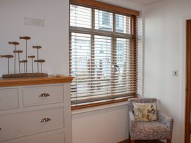 A living room with a window and chair at 5 Harbour Yard Salcombe