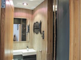 A bathroom with a sink and mirror at 5 Harbour Yard in Salcombe