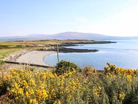 A view of a beach and water with mountains in the background at Whispering Pines, Durrus, County Cork