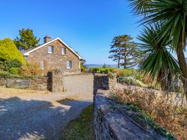 An outdoor view of a house with a gravel pathway and garden plants at Whispering Pines in Durrus, County Cork