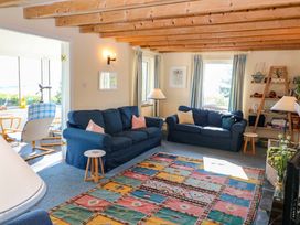 A living room with two sofas and a rug at Whispering Pines in Durrus, County Cork