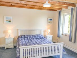 A bedroom with a bed and nightstands at Whispering Pines, Durrus, County Cork
