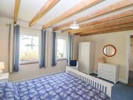 A bedroom with a bed and wardrobe at Whispering Pines in Durrus, County Cork