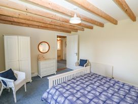 A bedroom with a bed and wardrobe at Whispering Pines, Durrus, County Cork