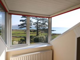 A window with a view of trees and water at Whispering Pines in Durrus, County Cork