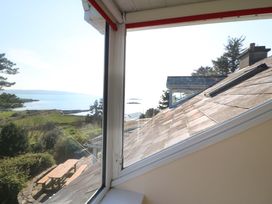 A view of the ocean and landscape from a window at Whispering Pines, Durrus, County Cork