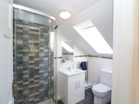 A bathroom with a shower, sink, and toilet at Whispering Pines, Durrus, County Cork