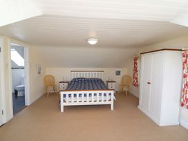 A bedroom with a bed and chairs at Whispering Pines in Durrus, County Cork