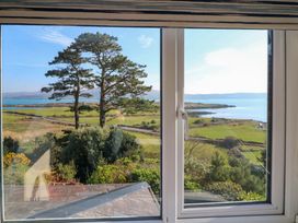 A view from a window showing trees and water at Whispering Pines in Durrus, County Cork