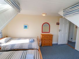 A bedroom with two beds and furniture at Whispering Pines in Durrus, County Cork