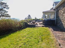 An outdoor area with a table and chairs near a house at Whispering Pines in Durrus, County Cork