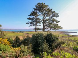 A view of trees and water with mountains in the distance at Whispering Pines, Durrus, County Cork
