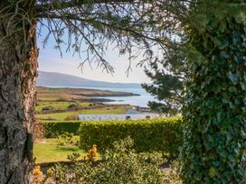 A view through trees overlooking the ocean at Whispering Pines Durrus, County Cork