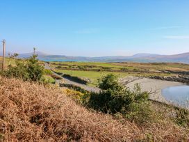 A landscape with a road and water in the background at Whispering Pines, Durrus, County Cork