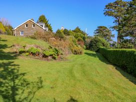 A house and garden with a pathway at Whispering Pines in Durrus, County Cork