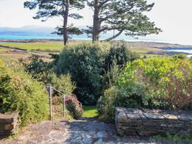 A garden with stone steps leading down to green grass at Whispering Pines in Durrus, County Cork