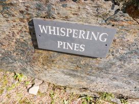 A sign displaying 'Whispering Pines' on a rock at Whispering Pines in Durrus, County Cork