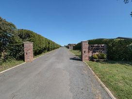 A view of a driveway with gates and hedges at Buttercup Lodge Runswick Bay near Staithes