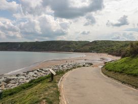 A beach with a path leading to water at Lilac Lodge in Runswick Bay near Staithes
