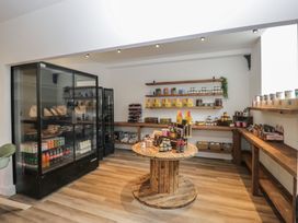 A shop interior with shelves and a display table at Canadian Cabin 37 Keswick