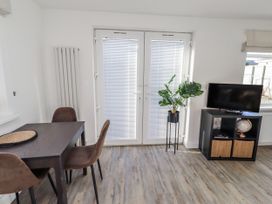 A dining room with a table and chairs at Old Colliery Cottage in Shilbottle
