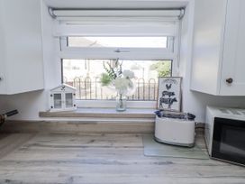 A kitchen countertop with a window and toaster at Old Colliery Cottage in Shilbottle