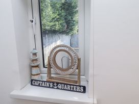 A decorative display with a lighthouse figurine and mirror at Old Colliery Cottage in Shilbottle