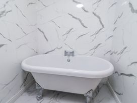 A bathroom with a freestanding bathtub at Old Colliery Cottage in Shilbottle