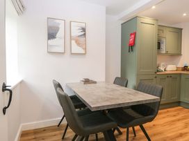 A dining room with a table and chairs at Riverside Cottage No 5 Keswick
