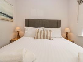 A bedroom with a bed and lamps at Riverside Cottage No 5 in Keswick