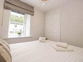 A bedroom with towels on the bed at Riverside Cottage No 5 in Keswick
