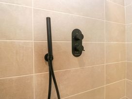 A shower panel and hose in a bathroom at Riverside Cottage No 5 Keswick