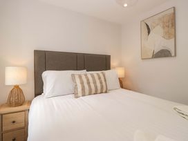 A bedroom with a bed and lamps at Riverside Cottage No 5 in Keswick