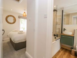 A bathroom with a bathtub and shower at Riverside Cottage No 5 Keswick