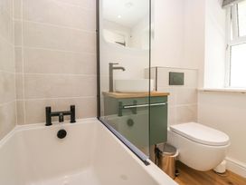 A bathroom with a bathtub and sink at Riverside Cottage No 5 in Keswick
