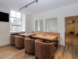 A dining room with tables and chairs at Greta House Keswick