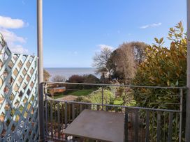 A view from a balcony overlooking the ocean and garden at 2 St Michaels House in Lyme Regis