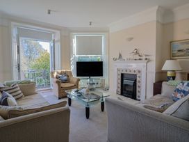 A living room with a television and coffee table at 2 St Michaels House in Lyme Regis